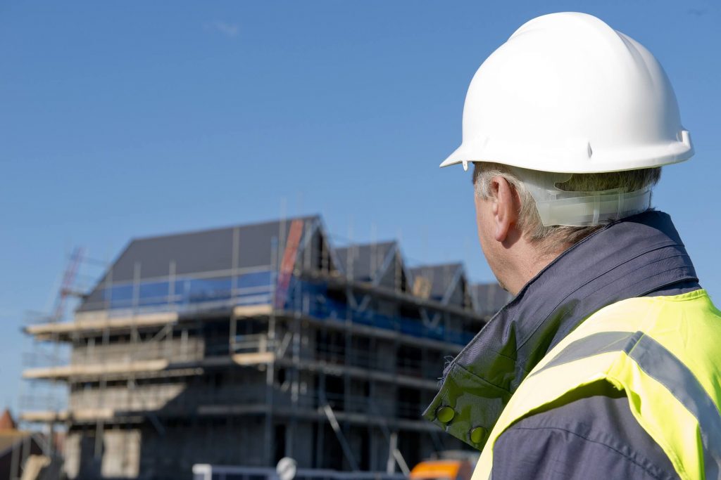 Builder Looking Back At Scaffolding